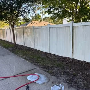 White vinyl fence after exterior cleaning