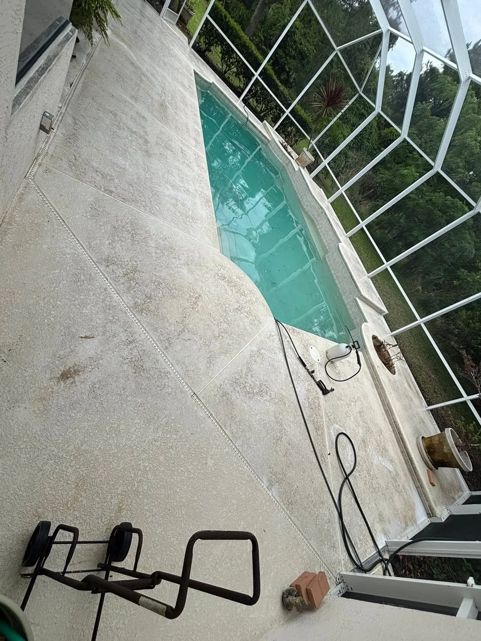 Freshly cleaned pool deck and screen enclosure